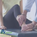 Therapist examining patient's ankle and foot during a treatment session