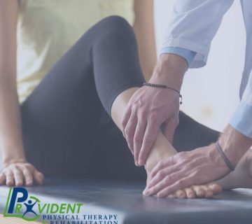 Therapist examining patient's ankle and foot during a treatment session