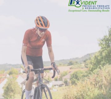 Person wearing an orange helmet and red cycling jersey rides a road bike outdoors; Provident Physical Therapy & Rehabilitation logo in the corner 